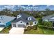 Aerial view of a charming house with a gray roof and light blue exterior, surrounded by lush landscaping at 4304 Fly Rod Ter, Parrish, FL 34219