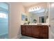 Bathroom boasts a large vanity with dark wood cabinets and a walk-in shower at 4304 Fly Rod Ter, Parrish, FL 34219