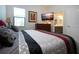 King-size bed in bedroom with mounted TV and ensuite bathroom at 4304 Fly Rod Ter, Parrish, FL 34219