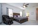 Main bedroom with a king-size bed and massage chair at 4304 Fly Rod Ter, Parrish, FL 34219