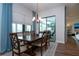Elegant dining room with a wood table, six chairs, and access to a patio at 4304 Fly Rod Ter, Parrish, FL 34219