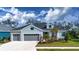 Two-story house with gray siding, gray double-car garage, and landscaping at 4304 Fly Rod Ter, Parrish, FL 34219