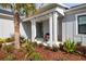Front porch with white columns, landscaping, and comfortable seating area at 4304 Fly Rod Ter, Parrish, FL 34219