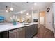 Open concept kitchen with island, stainless steel appliances, and white shaker cabinets at 4304 Fly Rod Ter, Parrish, FL 34219