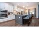 Modern kitchen with white cabinets, large island, and stainless steel appliances at 4304 Fly Rod Ter, Parrish, FL 34219