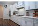Modern kitchen with white cabinets, stainless steel appliances and quartz countertops at 4304 Fly Rod Ter, Parrish, FL 34219