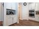 Modern kitchen with white cabinets, a built-in coffee bar and hardwood floors at 4304 Fly Rod Ter, Parrish, FL 34219