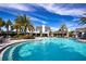Resort-style pool with palm trees and a clubhouse in the background at 4304 Fly Rod Ter, Parrish, FL 34219