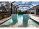 Relaxing pool with built-in seating and screened enclosure at 4304 Fly Rod Ter, Parrish, FL 34219