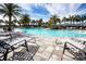Inviting pool with lounge chairs and palm trees at 4304 Fly Rod Ter, Parrish, FL 34219