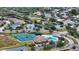 Aerial view showing community pool, tennis courts, and surrounding homes at 4519 Trout River Xing, Ellenton, FL 34222