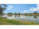 Serene pond view with reflections of the surrounding landscape at 4519 Trout River Xing, Ellenton, FL 34222