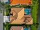 Aerial view of a house with a clay tile roof and a pool at 4917 Sabal Lake Cir, Sarasota, FL 34238