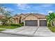 Beautiful two-story home with a three-car garage and manicured lawn at 4917 Sabal Lake Cir, Sarasota, FL 34238