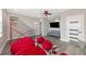 Fun game room with red beanbag chairs, basketball game, and flat-screen TV at 4917 Sabal Lake Cir, Sarasota, FL 34238