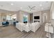Spacious living room with a fireplace and large windows at 4917 Sabal Lake Cir, Sarasota, FL 34238