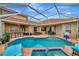 Inviting pool and spa with a covered patio, seating area, and bar at 4917 Sabal Lake Cir, Sarasota, FL 34238