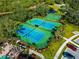 Aerial view of tennis courts and a basketball court in a community at 4917 Sabal Lake Cir, Sarasota, FL 34238