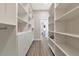 Large walk-in closet with ample shelving and drawers at 4917 Sabal Lake Cir, Sarasota, FL 34238
