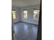 Well-lit bedroom with two windows and wood-look tile floors at 506 Houle Ave, Sarasota, FL 34232