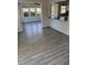 Bright dining room with wood-look tile floor and sunroom access at 506 Houle Ave, Sarasota, FL 34232
