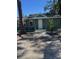 Charming green house with a landscaped yard and walkway at 506 Houle Ave, Sarasota, FL 34232