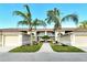 Condo building exterior showcasing walkway and tropical landscaping at 5250 Hyland Hills Ave # 1515, Sarasota, FL 34241