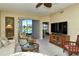 Spacious living room with view of water, large TV, and comfortable seating at 5250 Hyland Hills Ave # 1515, Sarasota, FL 34241