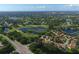 Aerial view showcasing the neighborhood's layout, golf course, lakes, and lush greenery at 5405 Champagne # 59, Sarasota, FL 34235