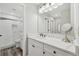 Modern bathroom with white vanity, marble countertops, and large mirror at 5405 Champagne # 59, Sarasota, FL 34235