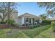 Exterior view of the back of the home, showcasing the lush lawn and sun room at 5405 Champagne # 59, Sarasota, FL 34235