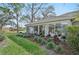 A naturally lit Florida room with neutral furnishings and a view of the landscaped backyard at 5405 Champagne # 59, Sarasota, FL 34235