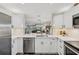 Modern kitchen with white cabinets and quartz countertops at 5405 Champagne # 59, Sarasota, FL 34235