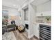 Living room showcasing a fireplace, wet bar with a wine cooler and wooden floors at 5405 Champagne # 59, Sarasota, FL 34235