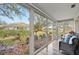 Relaxing sun room with wall-to-wall sliding glass doors overlooking the manicured backyard at 5405 Champagne # 59, Sarasota, FL 34235