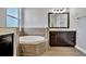 Bathroom with large soaking tub and dark brown vanity at 5607 Tidewater Preserve Blvd, Bradenton, FL 34208