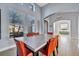 Bright dining room with a large table and orange chairs at 5607 Tidewater Preserve Blvd, Bradenton, FL 34208