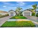 Two-story house with three car garage and manicured lawn at 5607 Tidewater Preserve Blvd, Bradenton, FL 34208