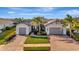 Two-car garage, attractive landscaping, and a welcoming front porch at 5607 Tidewater Preserve Blvd, Bradenton, FL 34208