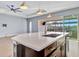 Kitchen island with sink, breakfast bar and view to backyard at 5607 Tidewater Preserve Blvd, Bradenton, FL 34208