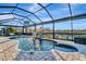 Screened pool and spa with water feature and brick pavers at 5607 Tidewater Preserve Blvd, Bradenton, FL 34208