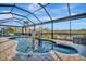 Enclosed pool and spa with a waterfall feature and comfortable seating area at 5607 Tidewater Preserve Blvd, Bradenton, FL 34208