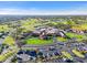 Aerial view of the clubhouse and community featuring golf courses and well-maintained landscaping at 5724 Doral Dr, Sarasota, FL 34243