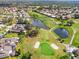 Stunning aerial view of the community showcasing the golf course, ponds, and well-maintained homes at 5724 Doral Dr, Sarasota, FL 34243
