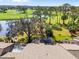 Beautiful backyard featuring a screened pool, lush landscaping and scenic golf course views at 5724 Doral Dr, Sarasota, FL 34243