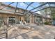 Screened patio featuring brick flooring, various seating areas, and views of the home's exterior at 5724 Doral Dr, Sarasota, FL 34243