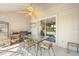 Cozy screened patio with tile floors, ceiling fan, and an outdoor dining area at 5724 Doral Dr, Sarasota, FL 34243