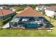 Aerial view of a house with a pool and lanai at 6625 Dovekey Dr, Sarasota, FL 34241