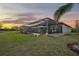 Spacious backyard with covered patio, pool, and fire pit at 6625 Dovekey Dr, Sarasota, FL 34241