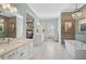 Large bathroom with double vanity, a soaking tub, and a walk-in shower at 6625 Dovekey Dr, Sarasota, FL 34241